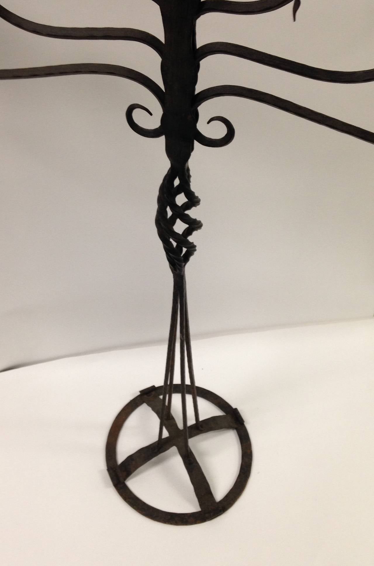 Standing iron candelabra, forged iron with seven lights. Base is a domed open strap, shaft is twisted. The seven lights are ornamented with leaf forms.
Swedish, handcrafted, circa 1940.