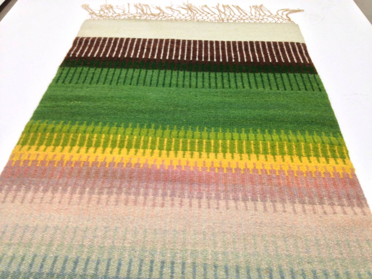 Finely woven wall art, flow of teak to pinks, yellow, greens to browns. Signed and dated Lana Lewis, 1986.
