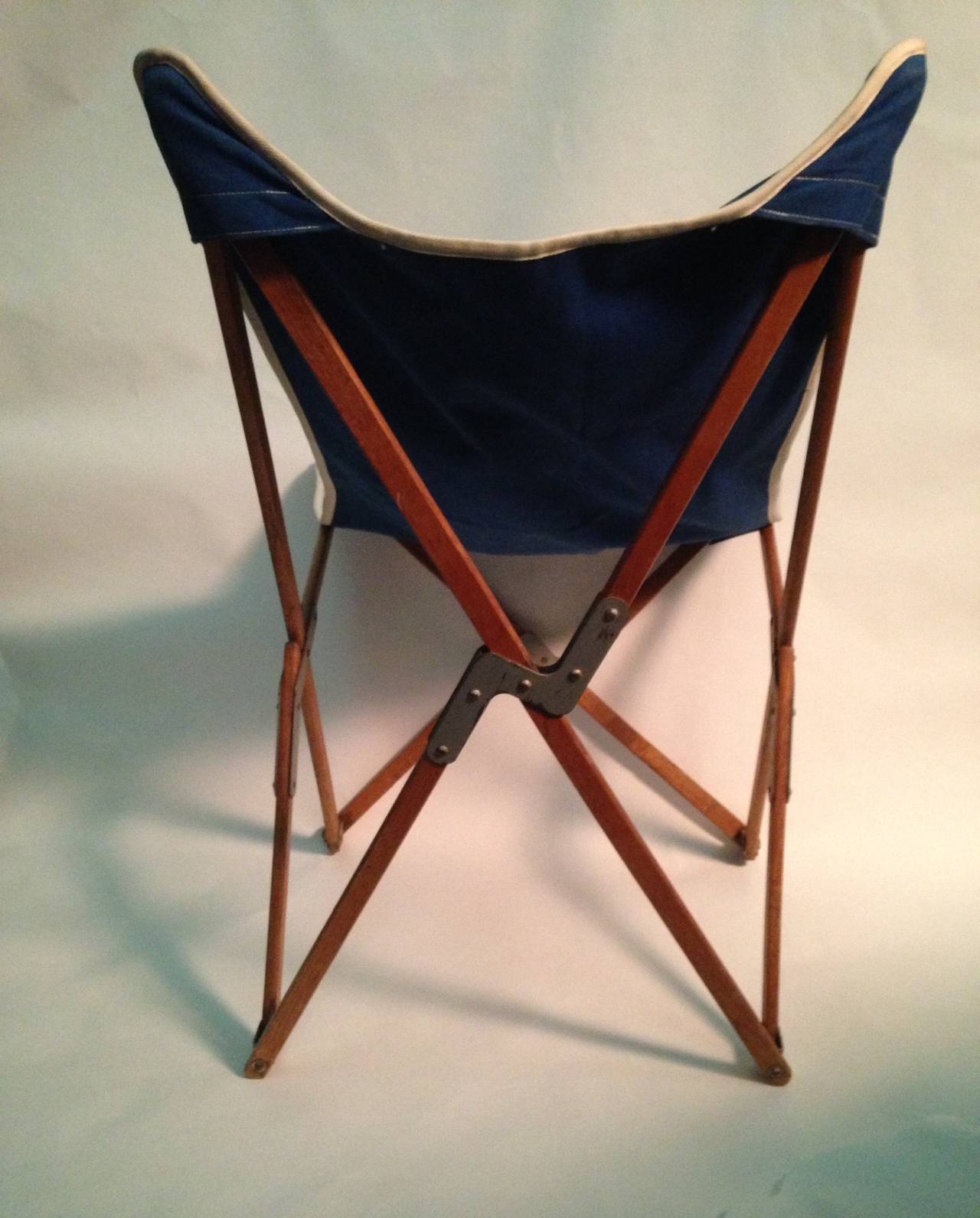Early wood folding chair (Adolescent Size) with canvas seat. Designed by Mogens Lassen. Sturdy hinged wood frame with Marine Blue canvas (piped in white) seat. Possibly a prototype size.