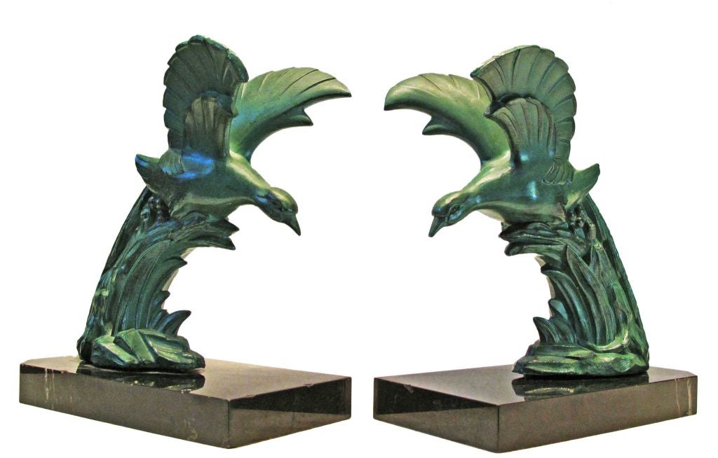 Beautiful pair of early twentieth century American bookends depicting a pair of mallards taking off for flight.