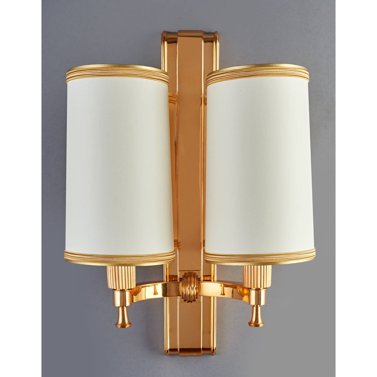 Maxime Old (1910-1991).
Two Pair of magnificent pair of polished bronze two-branch sconces with fluted mounts.
France, 1940s.
18 H x 12.5 W x 7.5 D or Backplate: 3 W.
Rewired for use in the U.S.
Reference: For this model p.109 Maxime Old by Yves