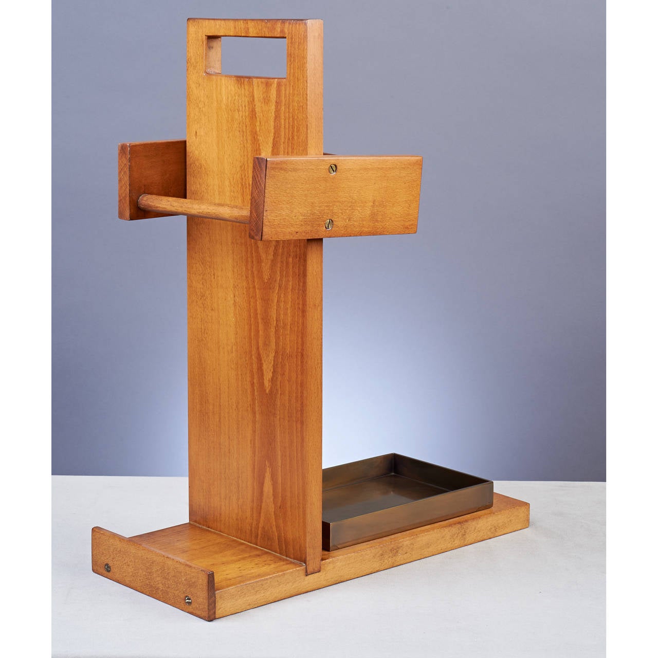 Andre Sornay (1902-2000).
 
Umbrella and cane stand.
Wood, bronze tray.
France, 1930s.
 
Measures: 18.5 x 9.5 x 23 H.

Reference: Thierry Roche, p.118.