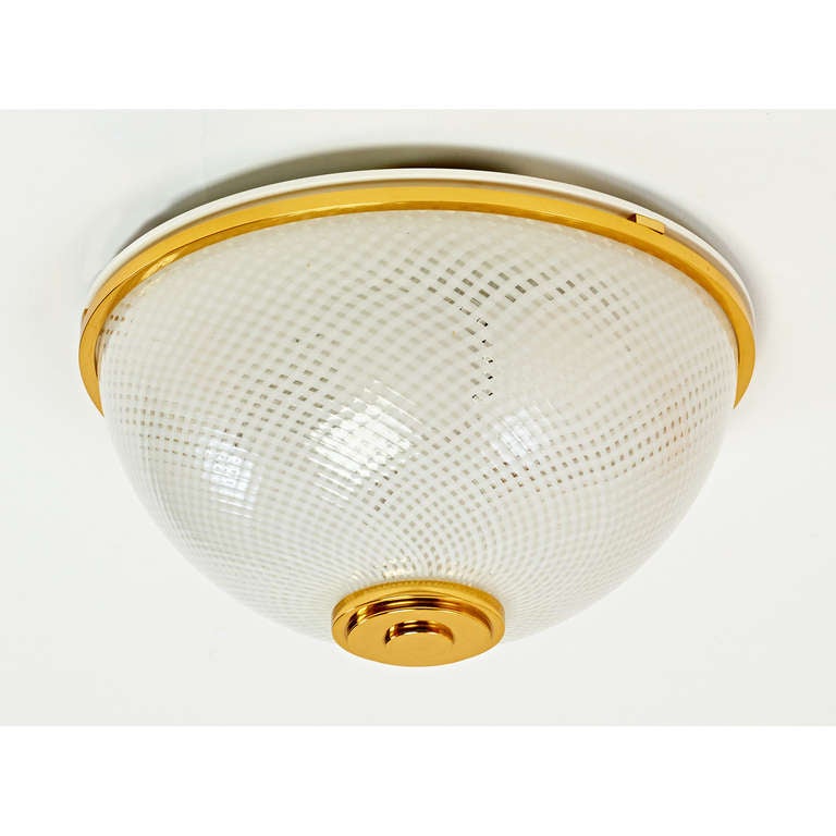 Italy, 1950s
An elegant round ceiling light with reticello glass by Venini,
polished brass mounts.
Rewired for use in the U.S.A. with two standard base bulbs up to 60 W each
Dimensions: 9.5 Ø x 5 H.