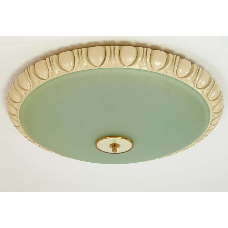 Fontana Arte.
A rare and monumental Fontana Arte flush-mount ceiling light. 
Frosted glass bowl; enameled carved wood frame with egg and dart motif. Maker’s mark on finial,
Italy, 1940s.
Dimensions: 32 Diameter x 6 H
Rewired for use in the U.S. with