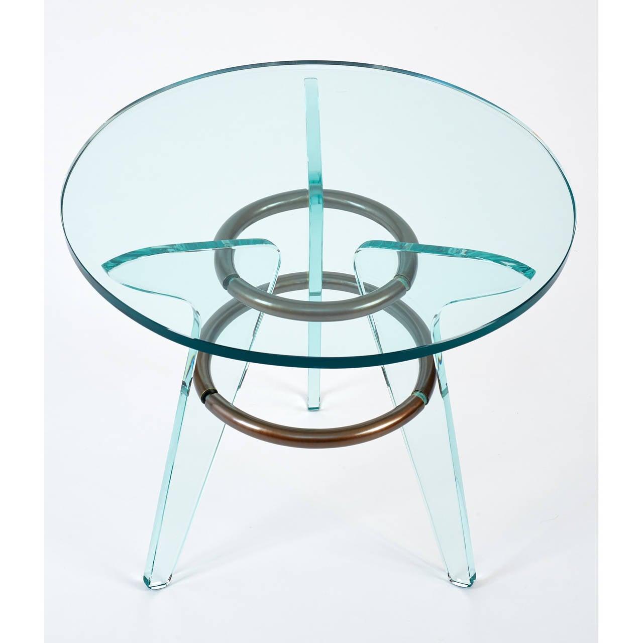 Italy, 1950s.

Modernist pair of three-legged glass tables with oxidized circular brass mounts.

Measures: 19.5 Ø x 18 H.

Two available and are sold individually.