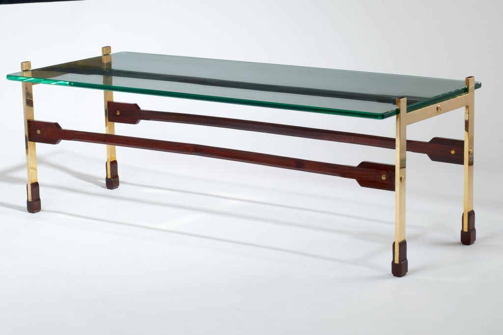 Sculptural long coffee table in rosewood and polished brass, glass top
Italy, circa 1960

Measure: 48 x 20 x 16 H.

 