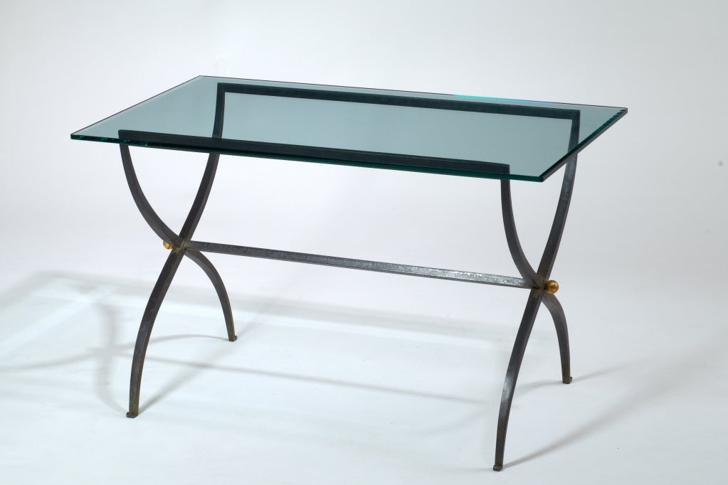 Elegant patinated wrought iron coffee table with clear glass top