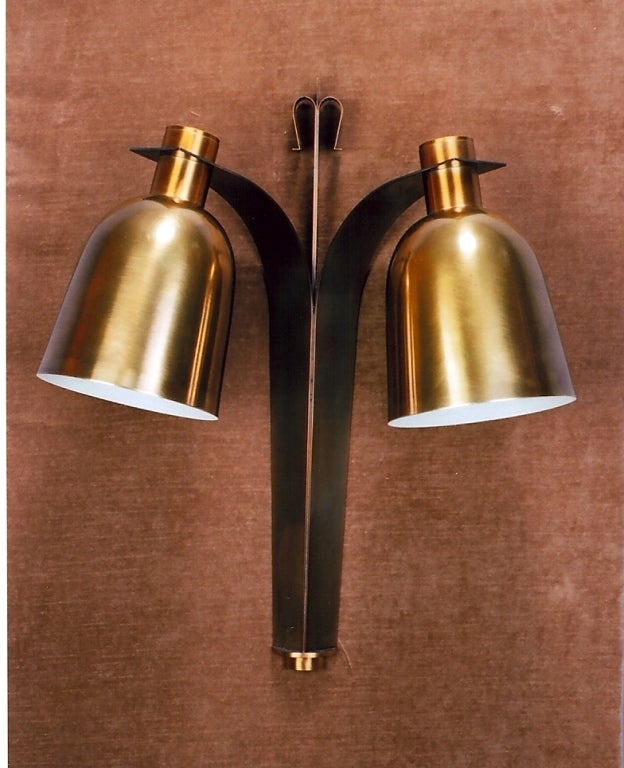 France, 1950s.
Handsome pair of two branch large bell shaped downlight sconces in oxidized brass.
Dimensions: 22 H x 18 W x 9.5 projection.
Rewired for use in the U.S.

