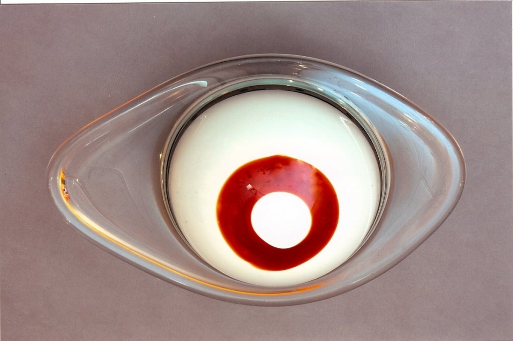 Italy, 1950s
Asymmetric oval blown glass ceiling light or sconce, the rim in thick clear glass, the white globe with a red circle at its center.
Nickeled metal mount.   Rewired for use in the USA.
Dimensions: 17 W x 11 D X 8 H
