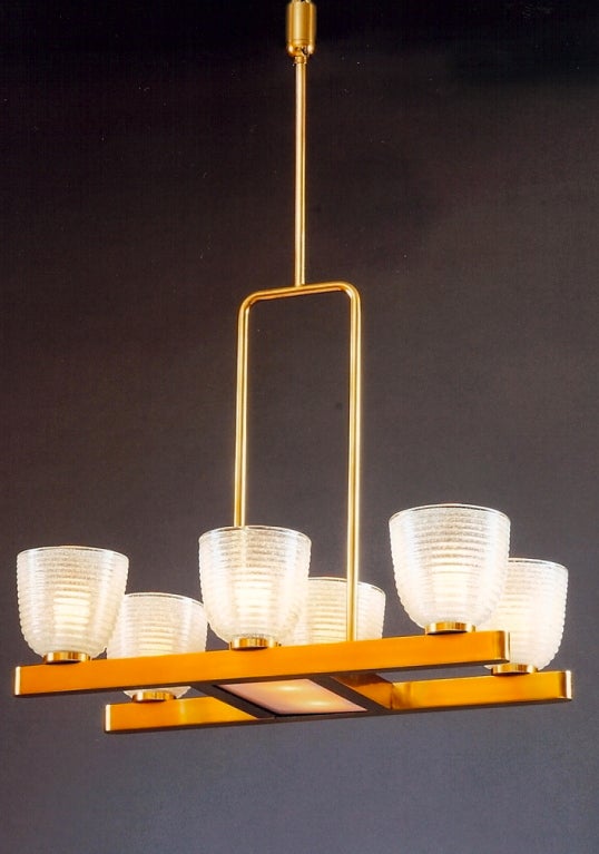 Modernist six branch Murano glass chandelier with blown Pulegoso glass shades, in the manner of Seguso.
Polished brass mounts. Italy, 1950s.
Dimensions: 29 W x 18 D x 42 H.
Rewired for use in the U.S.