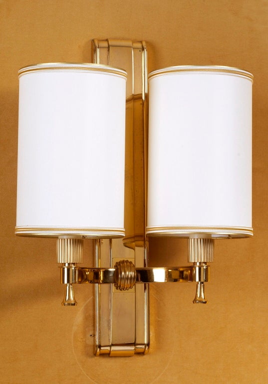 Maxime Old (1910-1991)
Magnificent pair of gilt bronze two branch sconces with fluted mounts.
France,1940's
Rewired for use in the U.S.