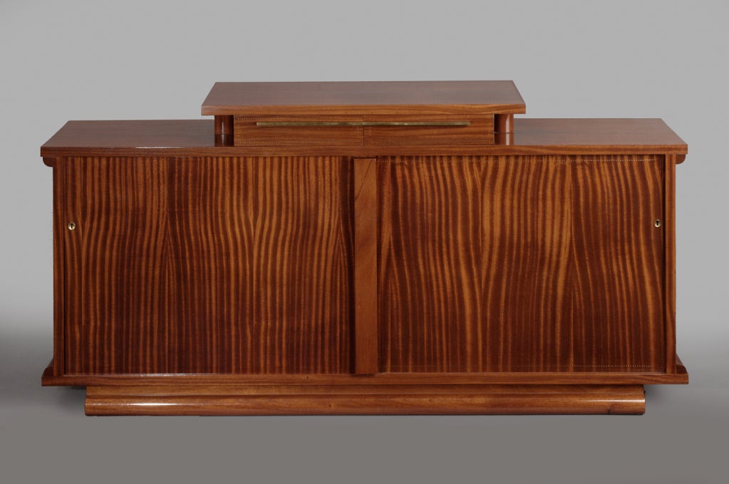 ANDRE SORNAY  (1902-2000)

Important and unique cabinet, with raised center, two drawers, sliding doors. 
Mahogany with cloutage decor
France 1930's 
Signed

REF: Thierry Roche, p. 91, for a photo of this cabinet

79 W  x  18/20 D  x  33/38