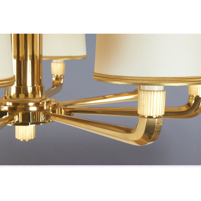 Genet Michon

Magnificent eight branch chandelier in polished bronze with faceted tapered arms, fluted mounts in contrasting matte finish, and acid washed globe. Original sculpted bronze canopy.
France,1930's

31 Ø x 42 H 

Height can be