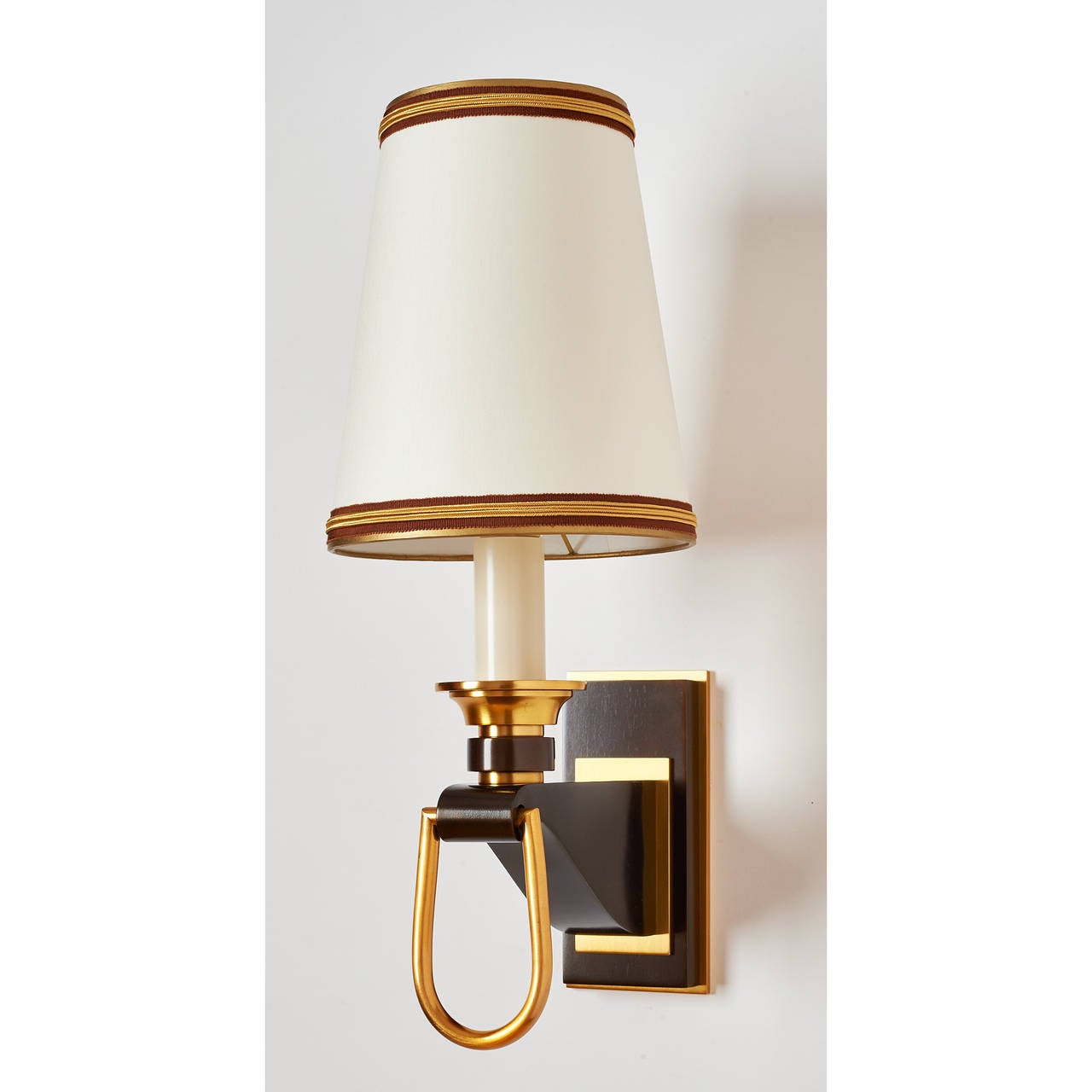 France, 1950s.
Elegant pair of oxidized metal sconces with stirrup motif and polished brass mounts.
Dimensions: 18 H x 7.5 W x  10 D.
Rewired for use in the USA.