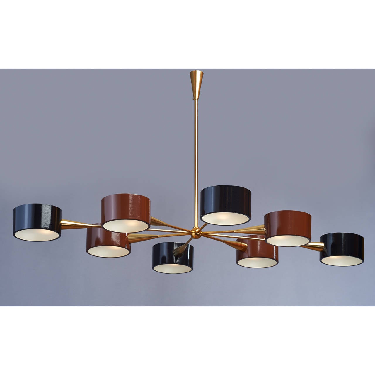 Italy, 1950s

Handsome eight light oval chandelier with black and brown enameled circular metal shades, frosted glass,
polished brass mounts.

47 x 31 x 24 H

Rewired for use in the USA