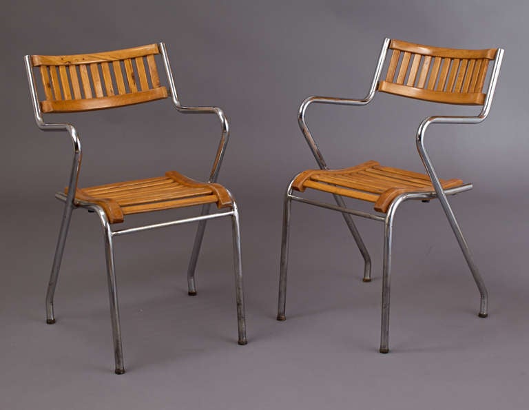 Unusual and sculptural pair of chromed tubular armchairs
with formed wood slat seat and rounded back, Italy, 1950s.
Manufacturer: Industria Mobili Parmense.
Manufacturer's label on back.
Dimensions: 19 W x 22 D x 18/32 H.

