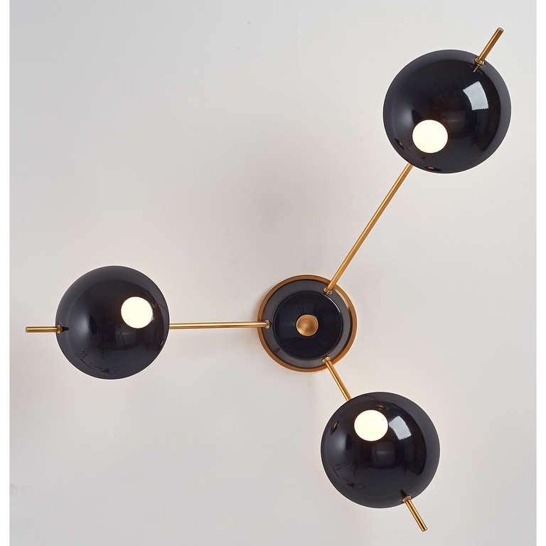 Stilnovo.
Rare asymmetric three branch wall light.
Black enameled metal and polished brass mounts, Italy, 1950s.
May also be ceiling mounted.
Rewired for use in the USA.

Longest am: 19