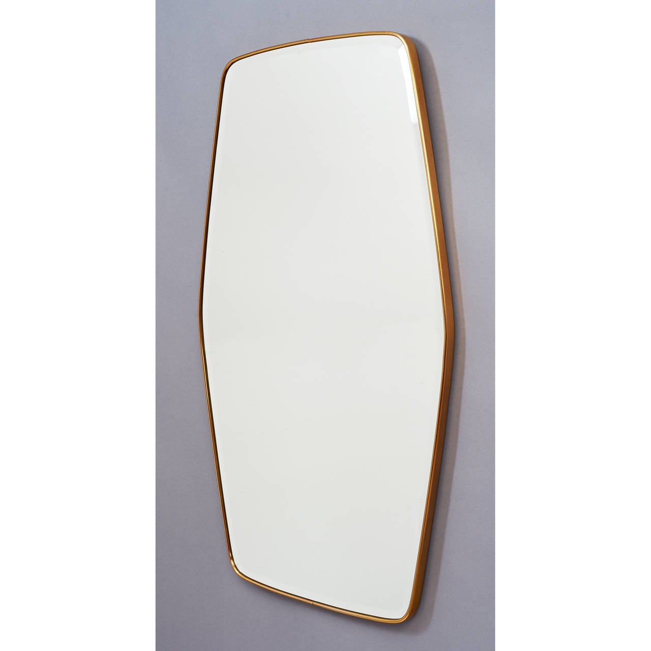 Fontana Arte.

Beveled mirror in lozenge form, with conforming brass frame.
Stamped on back with makers mark and date,
Italy, 1952.

Dimensions: 25 x 53.