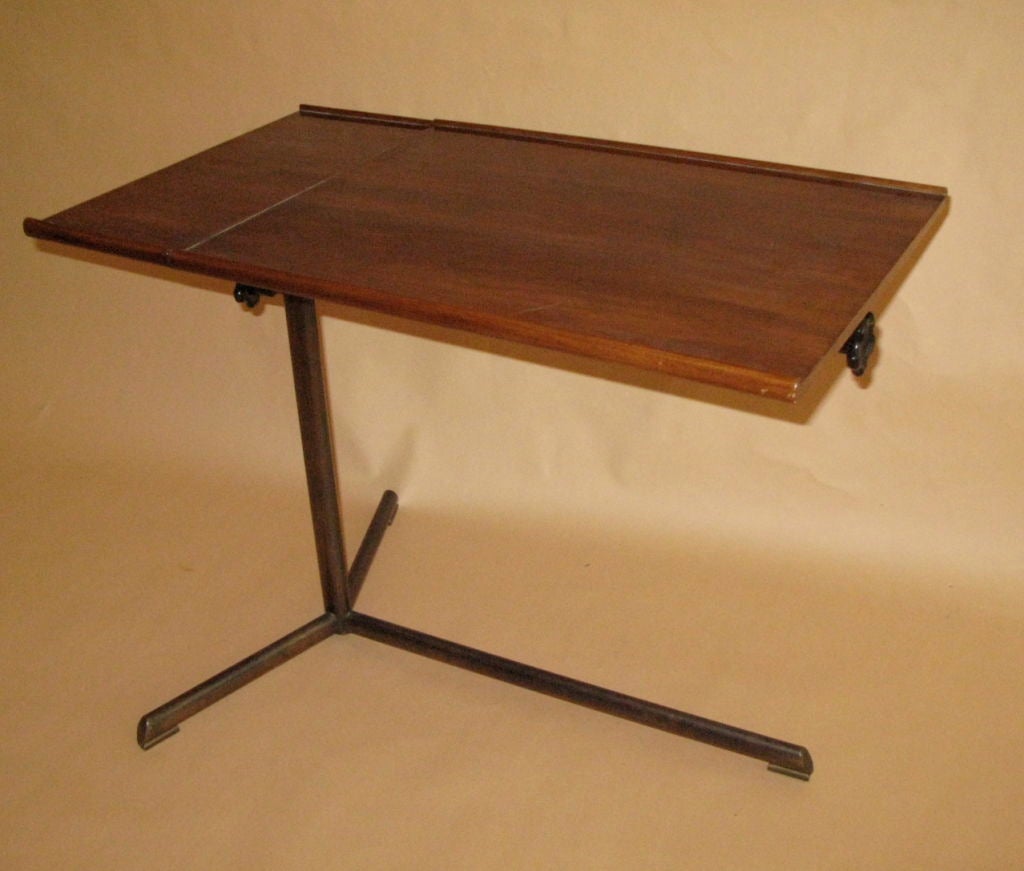 Suter Strehler
Adjusting reading or work table in walnut with oval tubular metal frame. The two sections pivot separately. Bears original label for Suter Strehler, Zurich.
Switzerland, 1950s.
