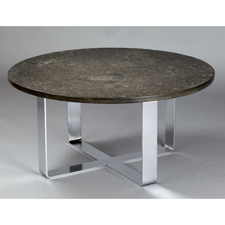 France, 1970s.
Cast and patinated coffee table with fossil shale relief, raised on chromed steel base.
39.5 diameter x 19.5 H.