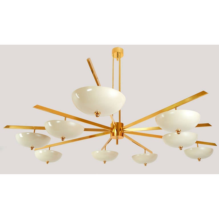 Italy, 1950s

An important nine branch asymmetrical chandelier in the manner of Angelo Lelii, the arms of three varying lengths in polished brass supporting nine enameled metal bowl shades.

May be used as a pendant or a flush mount