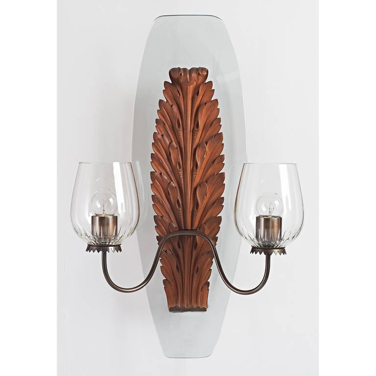 Franco Buzzi.
Pair of exceptional sconces with exquisitely carved wood acanthus leaves on shaped glass panel with engraved crystal shades.
Italy, 1950s.
Three pair available.
Sold by the pair
15 W x 8 Proj x 24 H.

Rewired for use in the US.