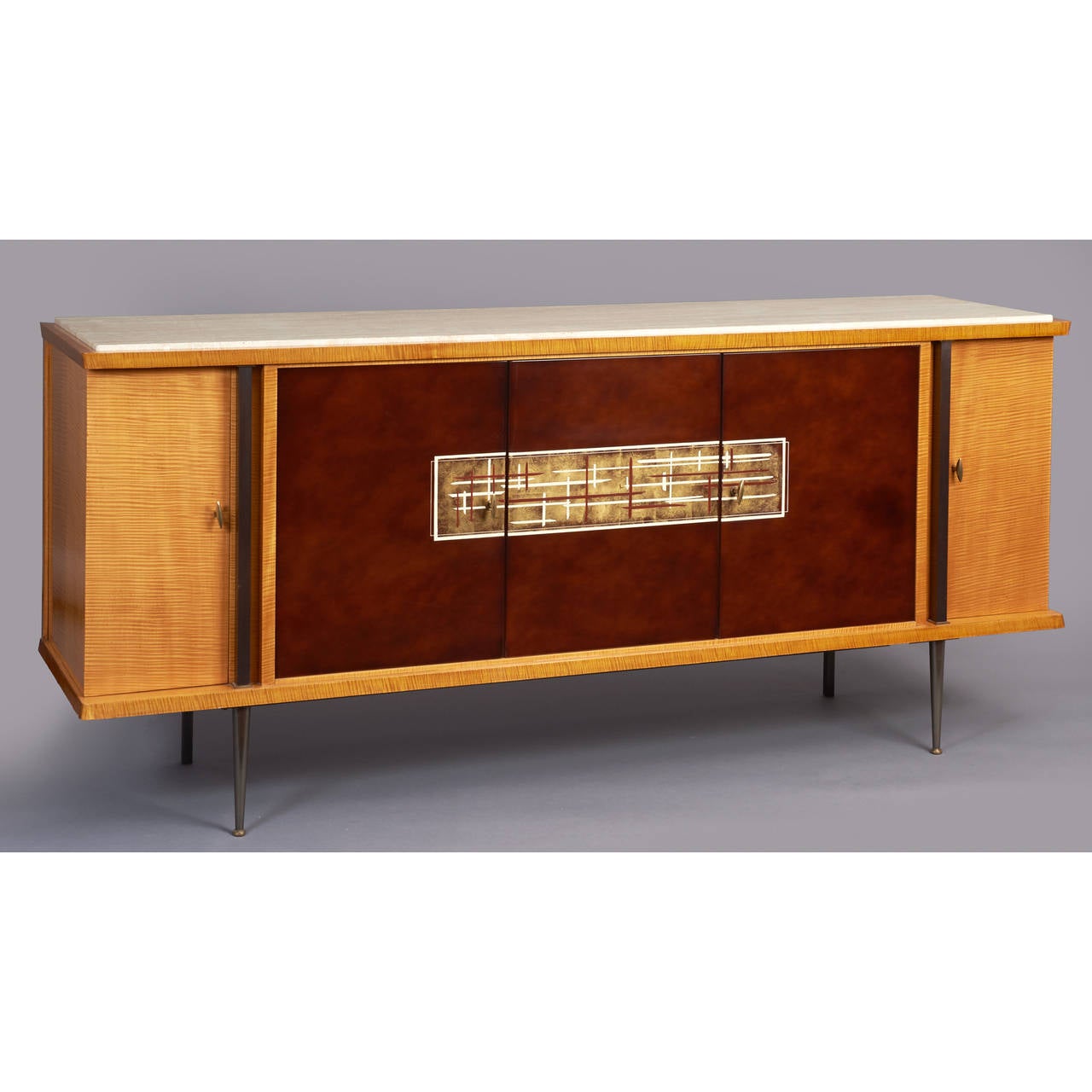 BATISTIN SPADE ( 1891-1969 )
A magnificent cabinet with three lacque nuage panel doors, 
unified by a gold leaf and enamel decorative abstract motif.
Blonde satin grained veneers, oxidized metal legs and pilastres,
travertine top.  Beautifully