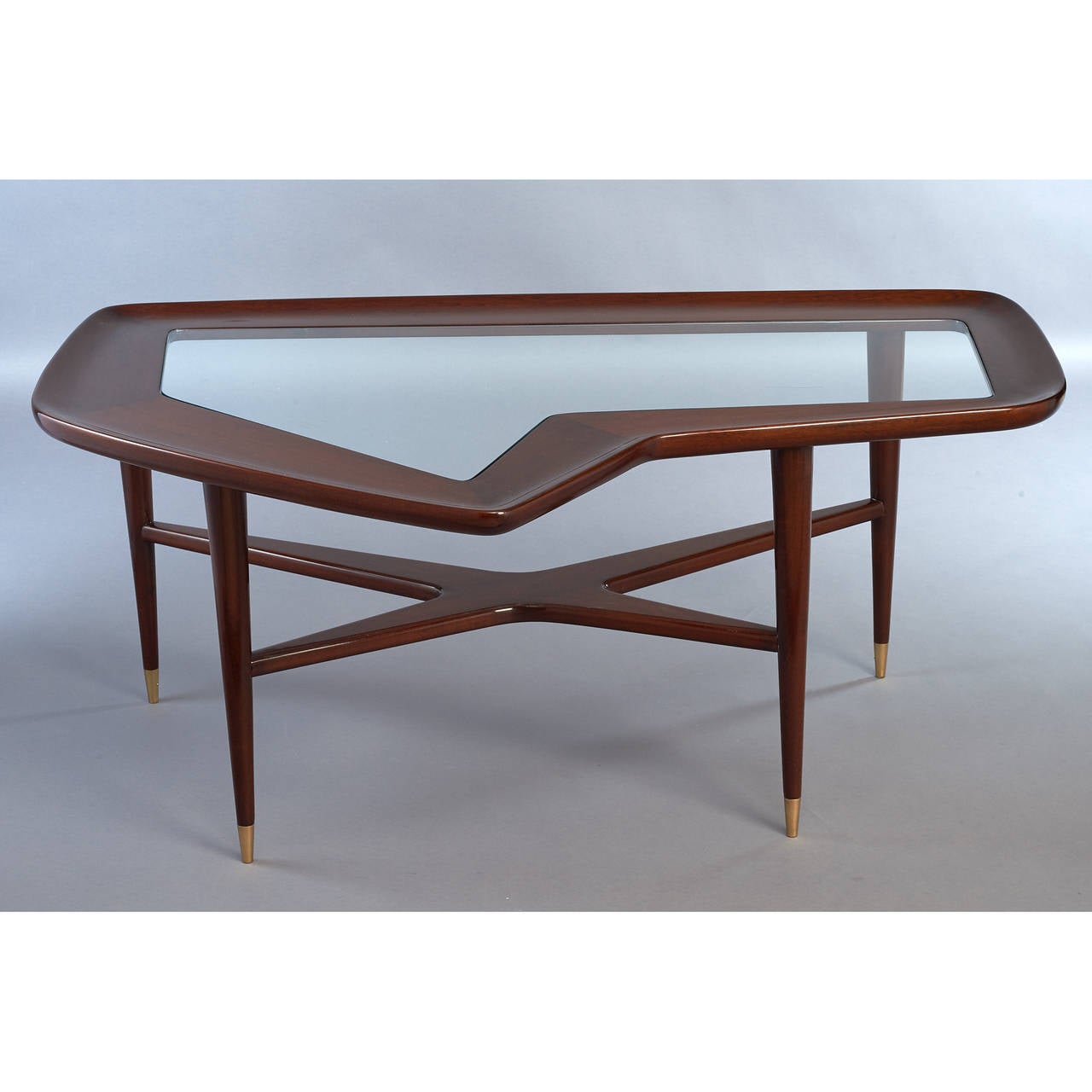 ITALY, 1950s

Sculptural free form coffee table 
Polished walnut with inset glass top 
Brass sabots

47 x 36 x 20 H