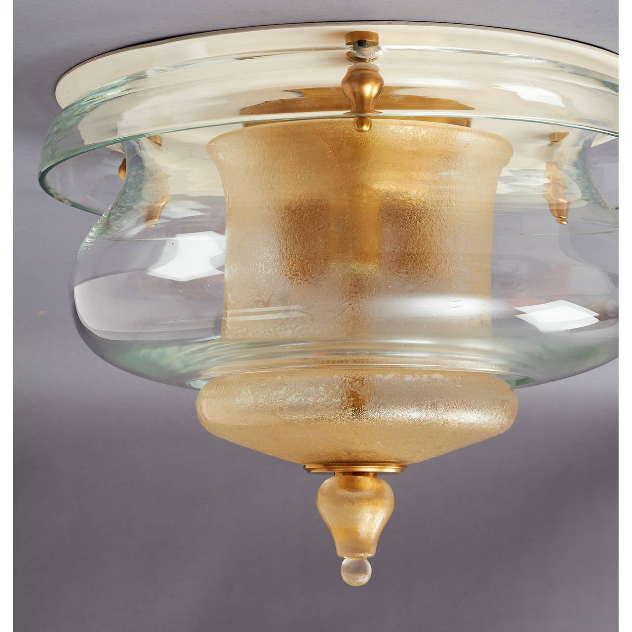 Veronese.

Exquisite ceiling light fixture.
Clear blown glass with gold flecked and acid washed central shade and finial.
Brass mounts.
Italy, circa 1950.

Measures: 14 diameter x 11 height.

Rewired for use in the U.S (3 bulbs).
