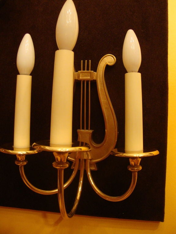 France, 1950s
Pair of three branch sconces in contrasting polished and matte brass with lyre motif. 
Rewired for use in the U.S.
10 W x 13 H x 7 D.