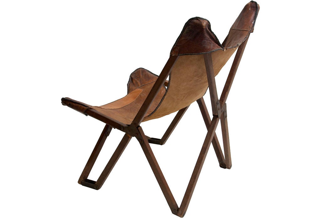 An antique wood and leather folding chair. This chair, which inspired the classic vintage Butterfly chair, was patented in 1877 by Joseph Fenby. Known as the 