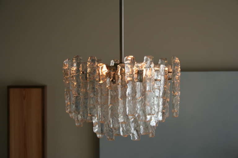 A glamorous 1960's Austrian glass pendant/chandelier. Textured glass is reminiscent of illuminated ice, seven lights (six on top, one inside) assure it provides adequate light for your space.