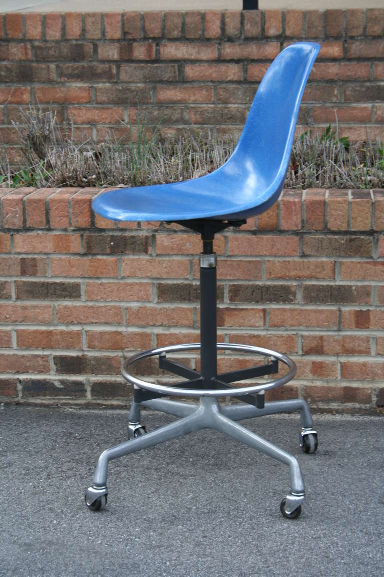A classic swivel drafting chair designed by Charles Eames for Herman Miller, c. 1970. This example features a fibrous blue side shell on a four star aluminum base with casters.  Great for stand up desks or to accompany a drafting table. 
Chair
