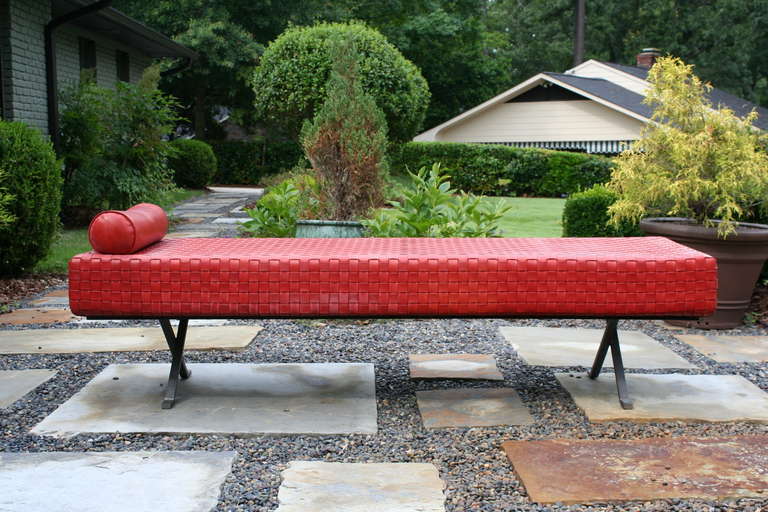 A beautiful woven red leather chaise lounge with leather pillow. Nice plated steel base. Stunning and well made.