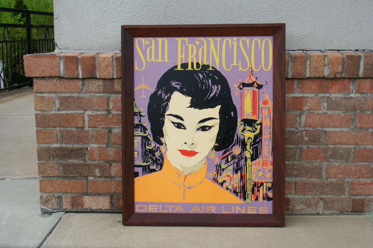 An interesting travel poster from Delta Air Lines, encouraging travel to San Francisco. Beautiful colors and art, showcasing the rich multicultural history of this fine city. 
Poster is mounted on wood and remains in its original dark walnut frame.