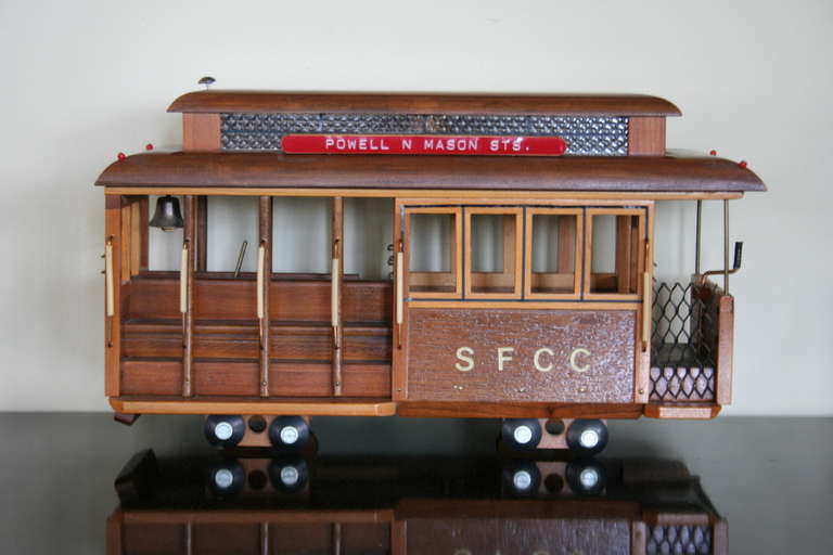 A well executed, handmade model of this historic San Francisco cable car. Nice detail and accents throughout. Music box inside winds and plays 'I left my heart in San Francisco.' A  nifty decorative piece. Signed by artist.