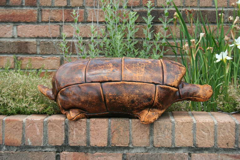 A rare, hand made English leather turtle stool designed and produced by Dimitri Omersa and retailed by Abercrombie & Fitch in the 1950's. Turtle is stamped 'Made in England' on the underside.