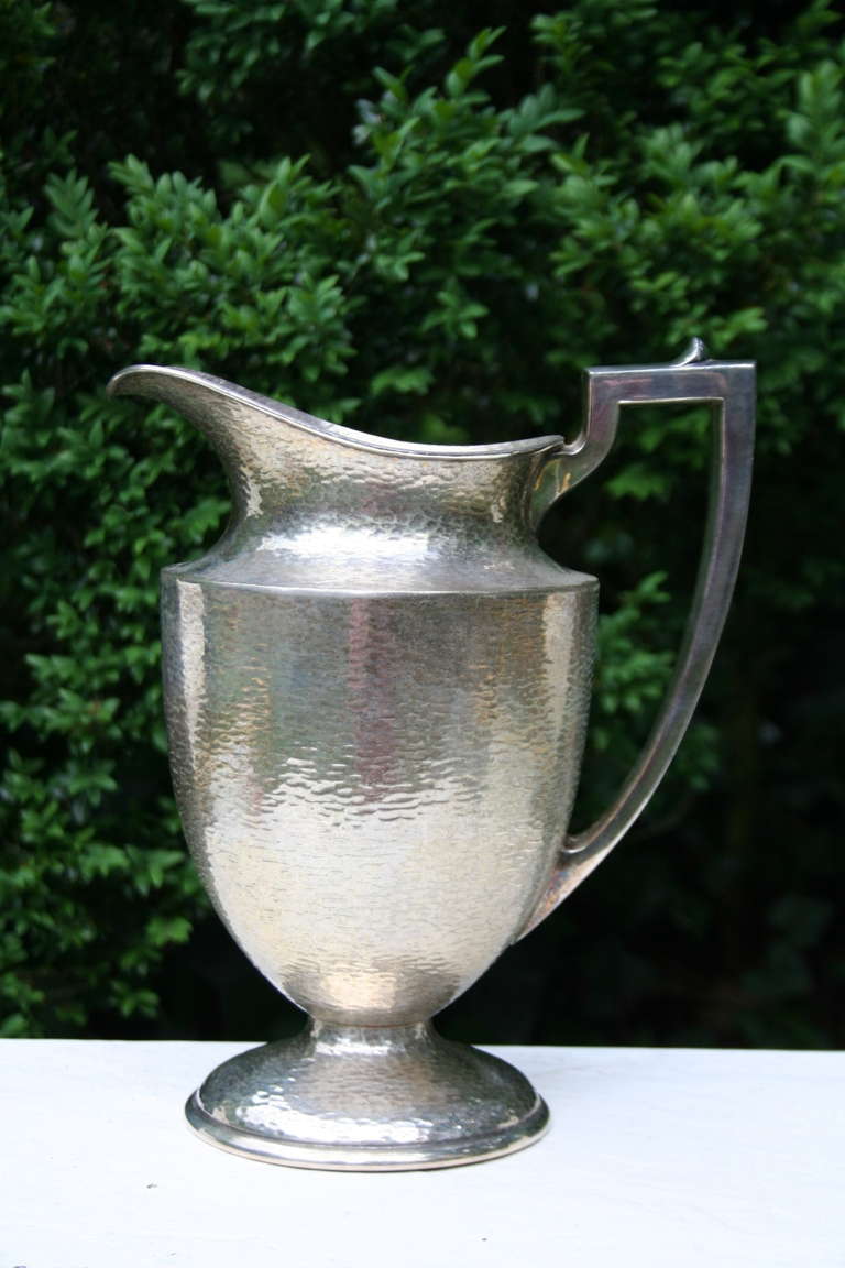 A beautiful hand hammered silver plated pitcher by W.M. Mounts, c. 1930. Balanced and sculptural, this is a lovely water/cocktail pitcher. Made in USA, Model 0154.