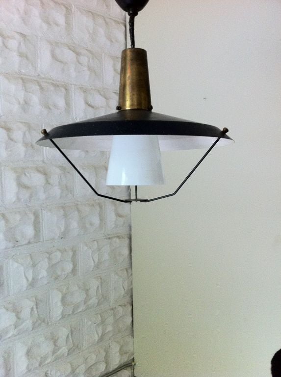 Functional ceiling mount retractable pendant light - metal reflector top accented with a brass neck and a smoked glass bulb cover. Very versatile with height adjustment. Functional alternative to a chandelier or floor lamp.