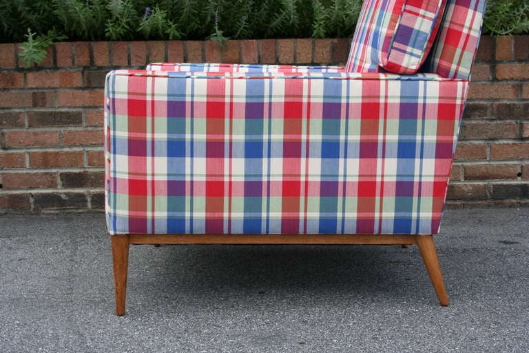 A  bright and fun plaid upholstered walnut lounge chair by Paul McCobb, c. 1957. Clean and simple lines throughout. A handsome chair.