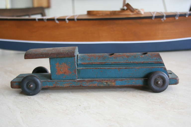 A sharp, vintage 1930s model train car. Long, exaggerated lines scream early 20th century American design. A great shelf piece.