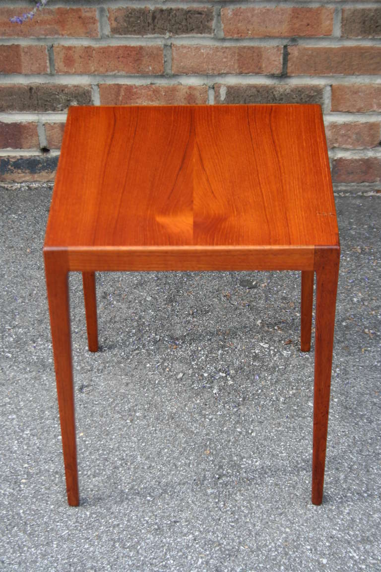 A well designed teak side table designed by Kurt Ostervig for Illums Bolighus, late 1960's. Bookmatched teak grain on top, excellent construction throughout.