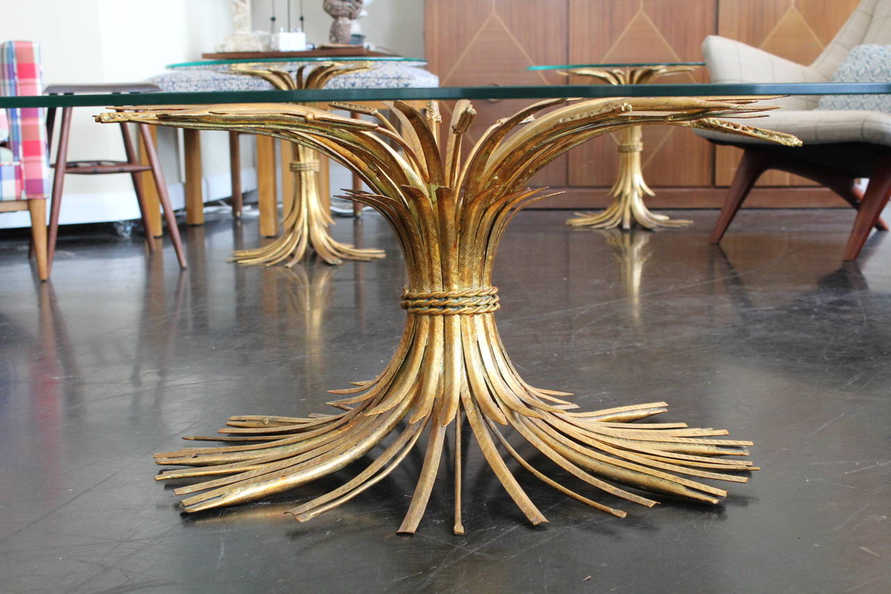 Beautiful sheaf of wheat cocktail table with its original oval glass top. Very clean with a lovely brass finish, rope detail in the center. Pair of matching side tables also available.