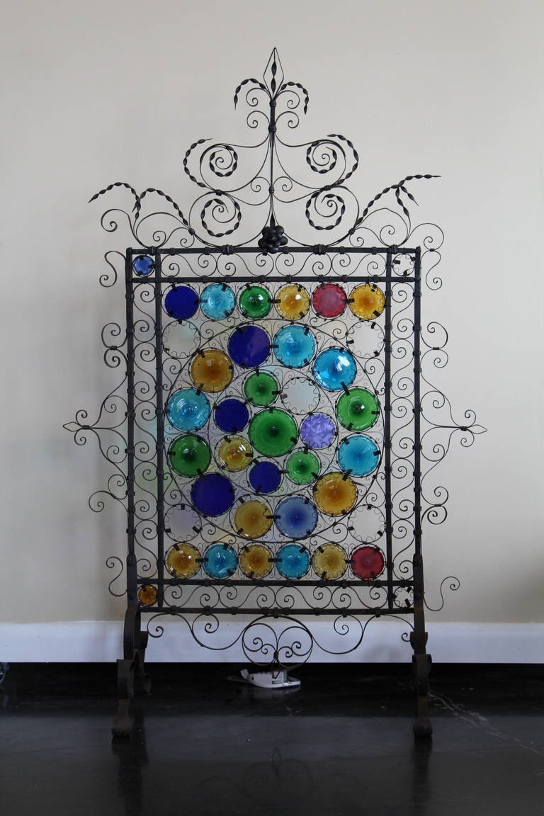 Beautiful glass bullseyes and sculptural wrought iron fire screen - late 1800's - early 1900's.