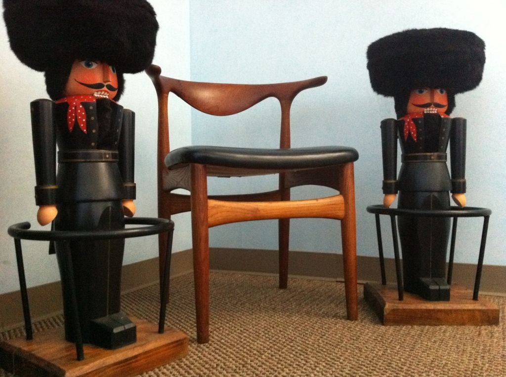 Beautiful matching pair of German nutcracker barstools - Magnificent attention to detail in craftsmanship and painting.  Back lever opens and closes the mouth, accented with a faux fur hat (seat). Sits on a wood base, iron footrest surrounds the