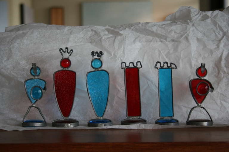 A wonderfully bright and entertaining studio made chess set with blue and red glass pieces, encased by a thin, malleable steel. A one of a kind set.