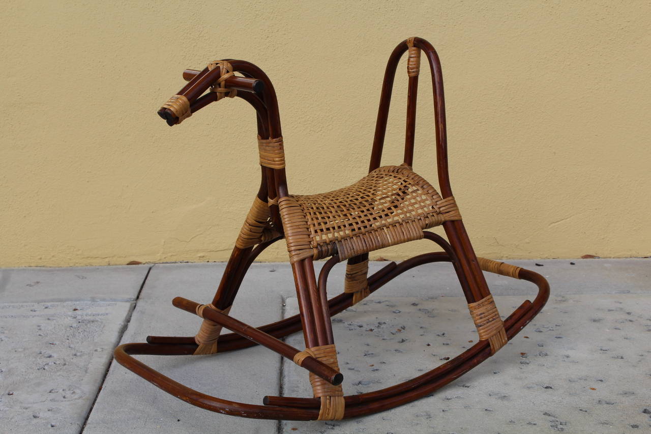 A super cute cane and rattan rocking horse, Sweden, 1960's. Rocker is sturdy and the caning is original and complete.