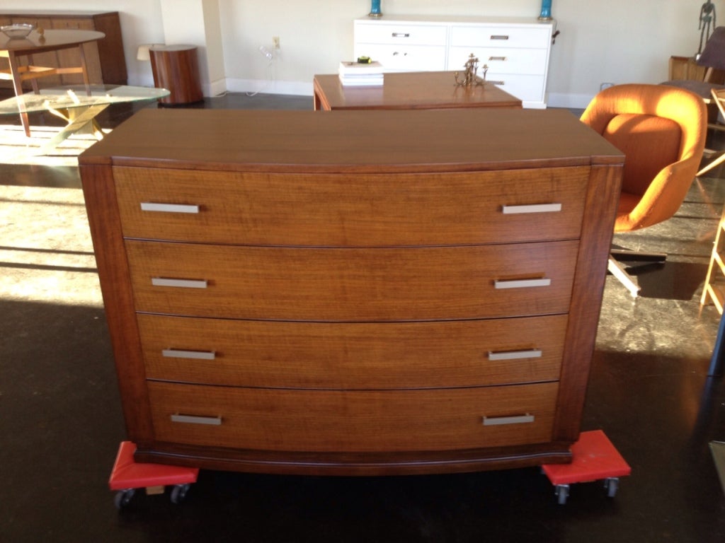 Stunning chest of drawers by famed Arts and Crafts maker, Limbert Furniture, Grand Rapids. A well constructed piece featuring  solid mahogany drawers, walnut sides and a beautiful mahogany top.  Bow front design adds nice depth and sophistication.