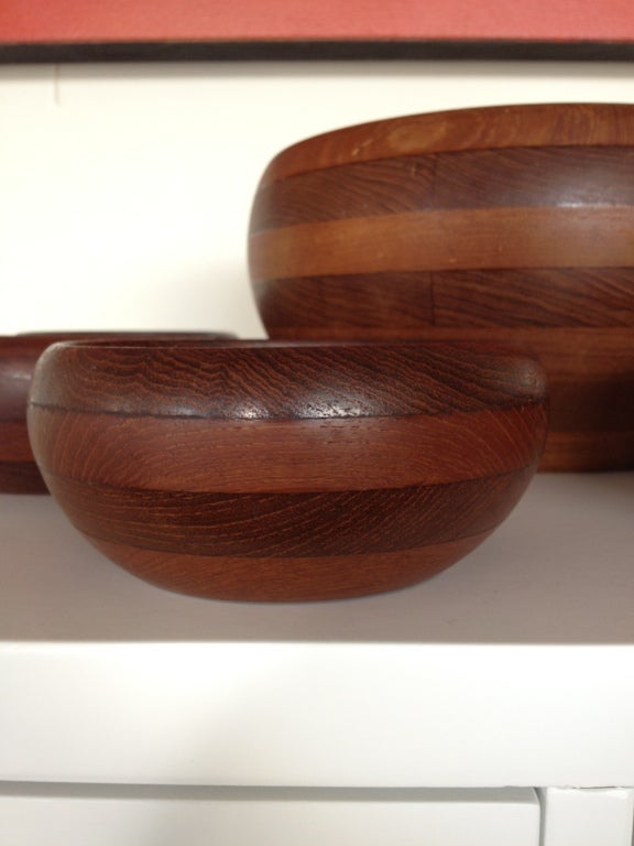 A wonderful complete early Danish salad set produced by Wiggers in the 1950's for Illums Bolighus. Constructed of staved teak, each bowl is expertly crafted and in excellent condition.  This set is reminiscent of several pieces designed by Jens