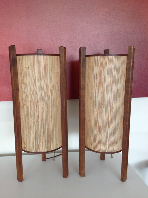 A unique pair of Japanese style cherry wood and woven grass table lamps, in the style of Isamu Noguchi, possibly produced for Knoll. Each lamp measures 20